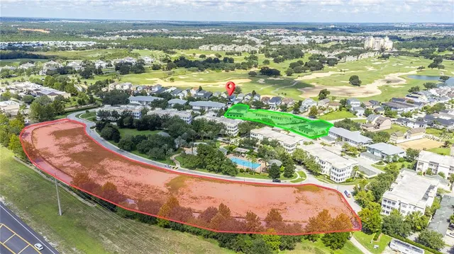 an aerial view of residential building and lake