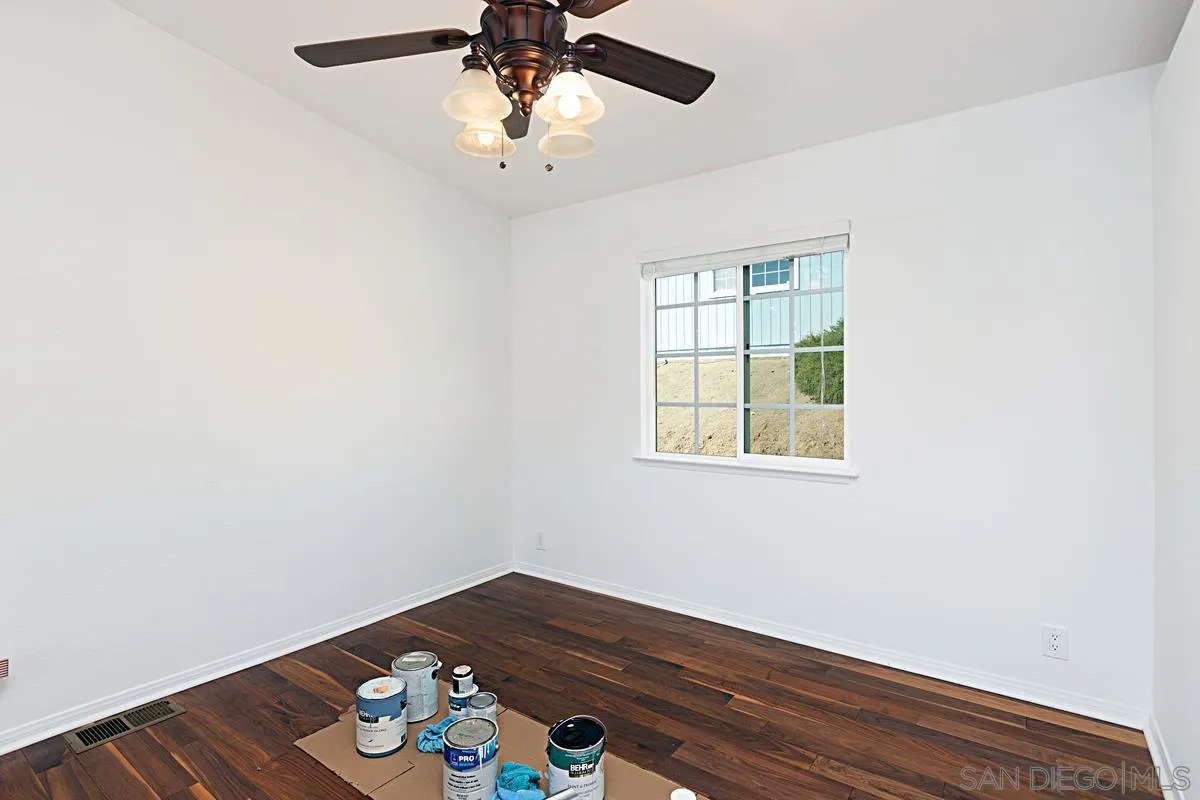 1064 Ranchito Vista Alpine, CA 91901 - Photo 15 of 31 an empty room with wooden floor and windows