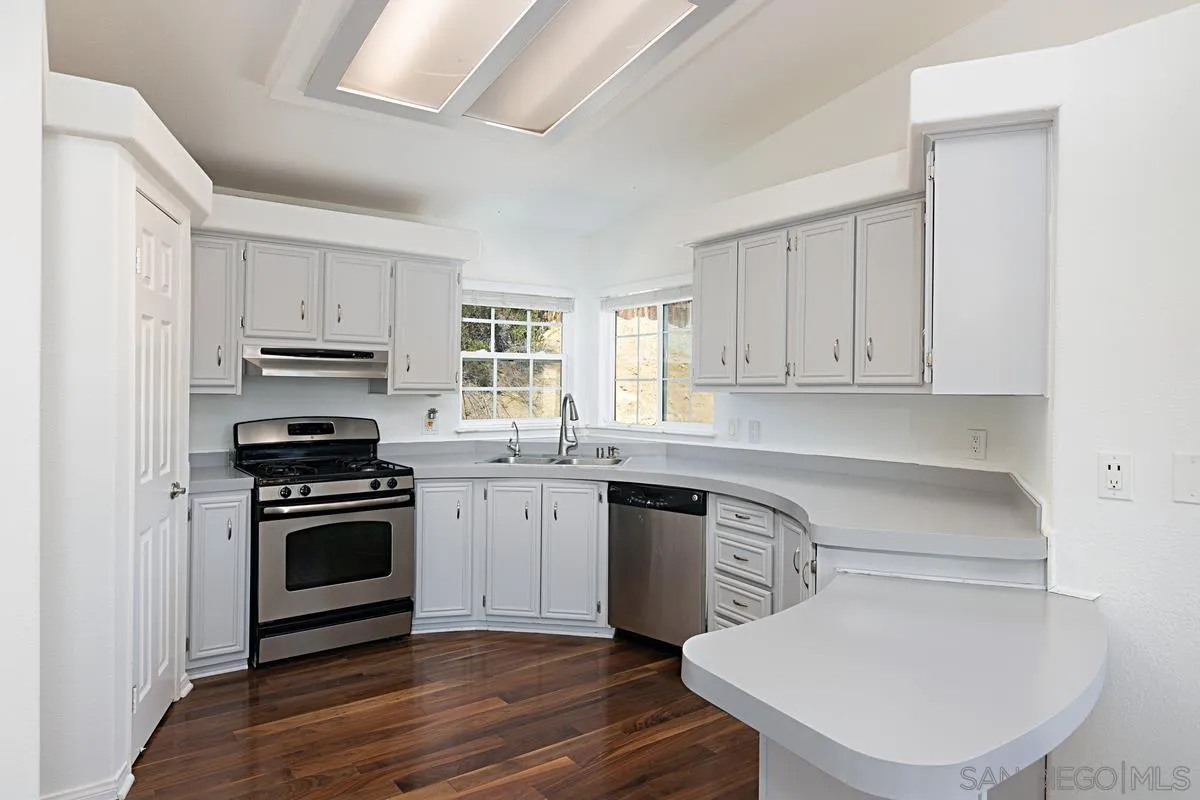 1064 Ranchito Vista Alpine, CA 91901 - Photo 18 of 31 a kitchen with cabinets stainless steel appliances and wooden floor