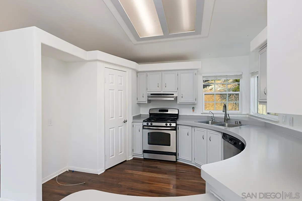 1064 Ranchito Vista Alpine, CA 91901 - Photo 21 of 31 a kitchen with a sink a stove and cabinets