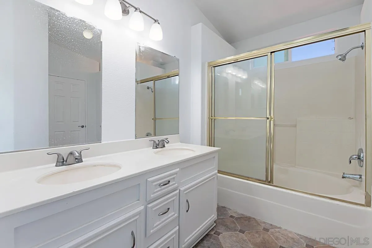 1064 Ranchito Vista Alpine, CA 91901 - Photo 24 of 31 a bathroom with a shower sink vanity and mirror