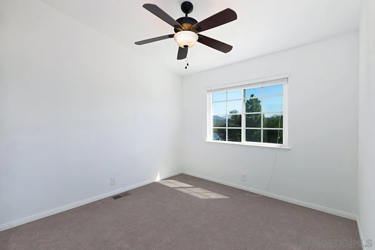 1064 Ranchito Vista Alpine, CA 91901 - Photo 25 of 31 an empty room with a window and a fan