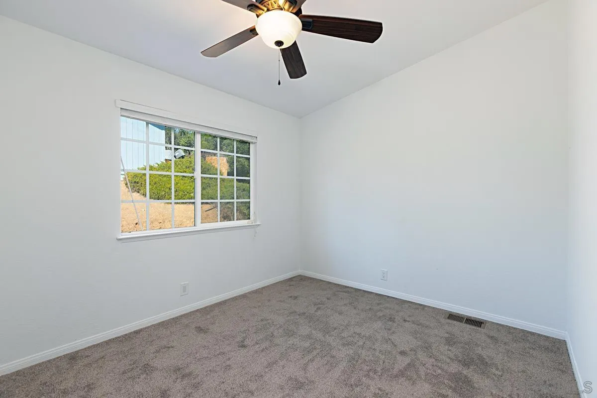 1064 Ranchito Vista Alpine, CA 91901 - Photo 27 of 31 an empty room with a window and a fan