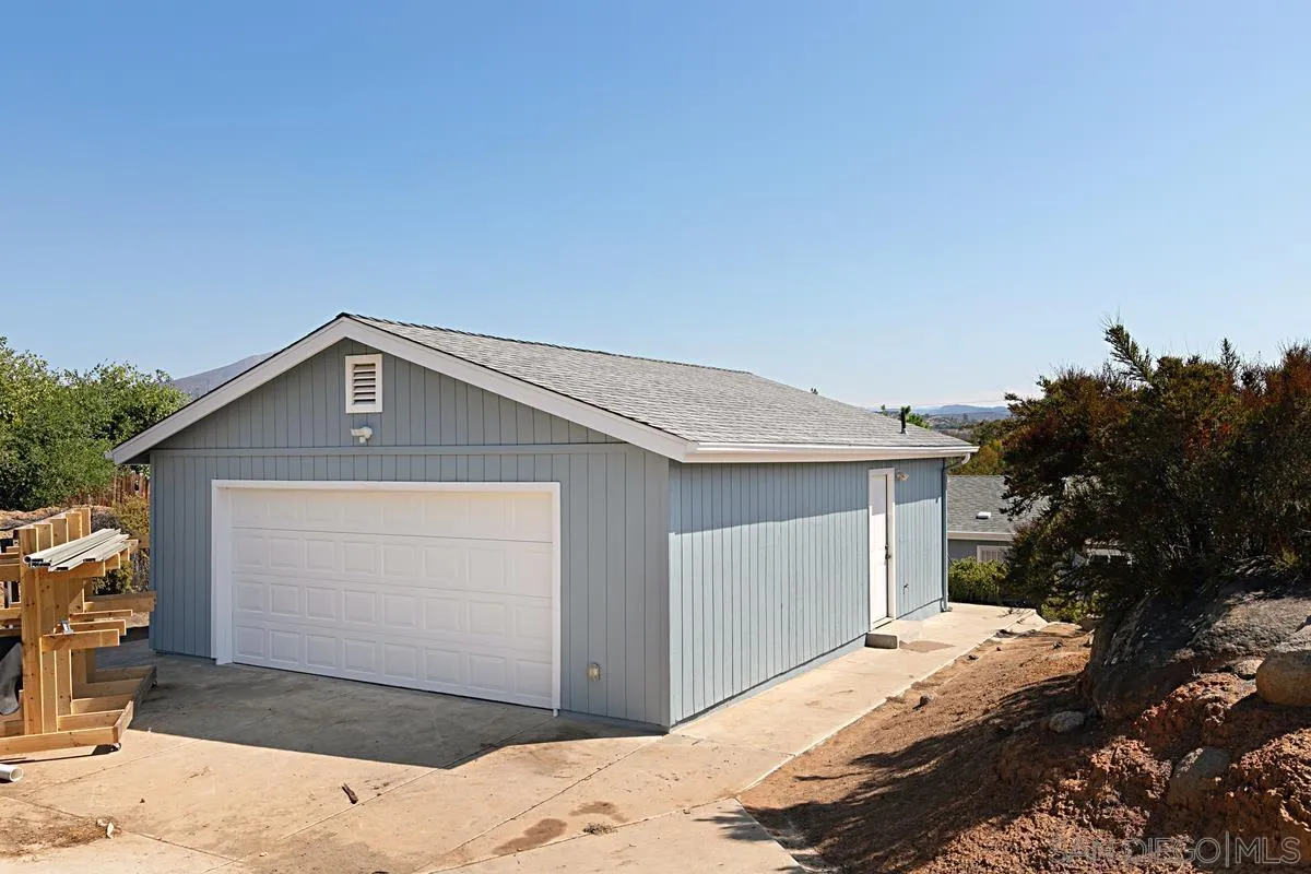 1064 Ranchito Vista Alpine, CA 91901 - Photo 5 of 31 a front view of a house with a yard and garage