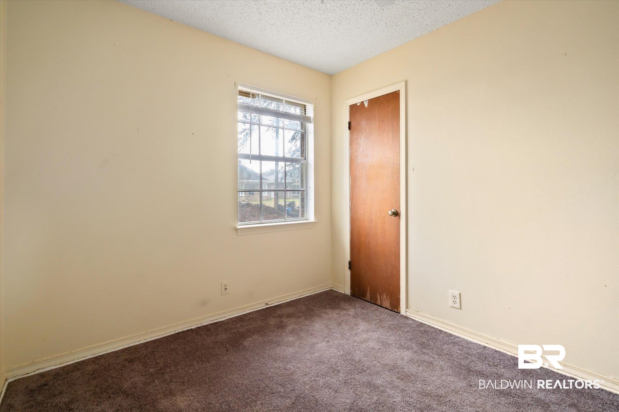 313 West 4th Avenue Foley, AL 36535 - Photo 14 of 20 Unfurnished room featuring a textured ceiling and carpet