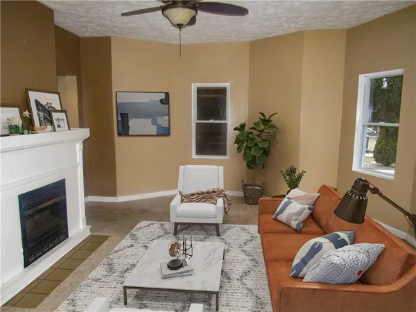 a living room with furniture rug and a fireplace