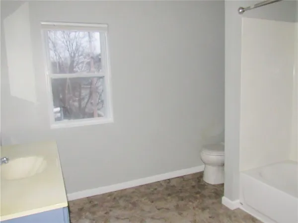 a bathroom with a toilet and a tub