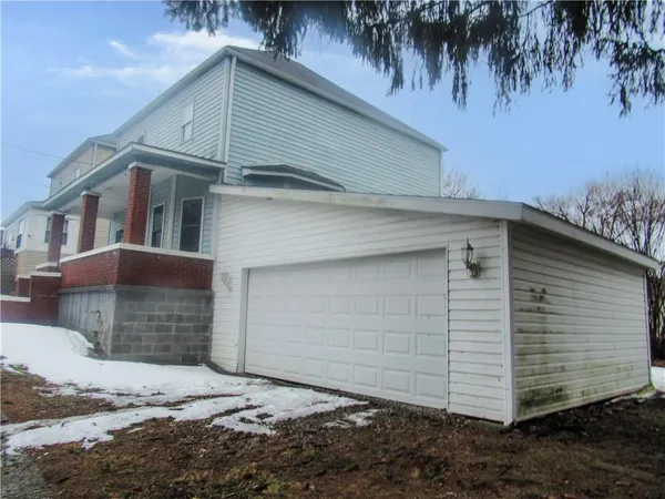 a view of a white house with large windows