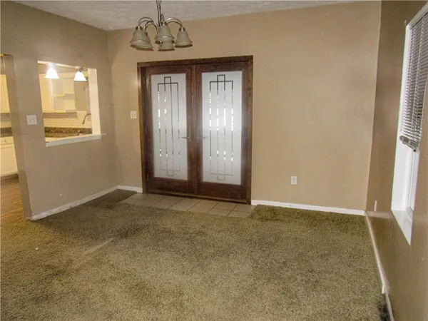 an empty room with windows and entrance