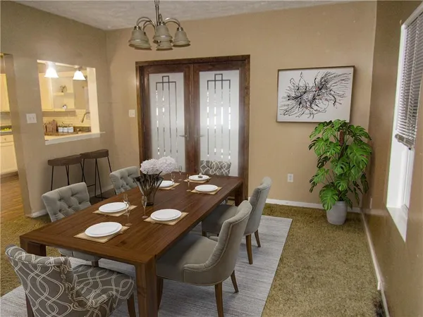 a view of a dining room with furniture and window