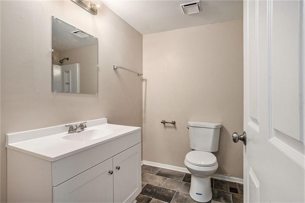 2039 Raintree Place Lithonia, GA 30058 - Photo 14 of 18 a bathroom with a sink toilet and mirror