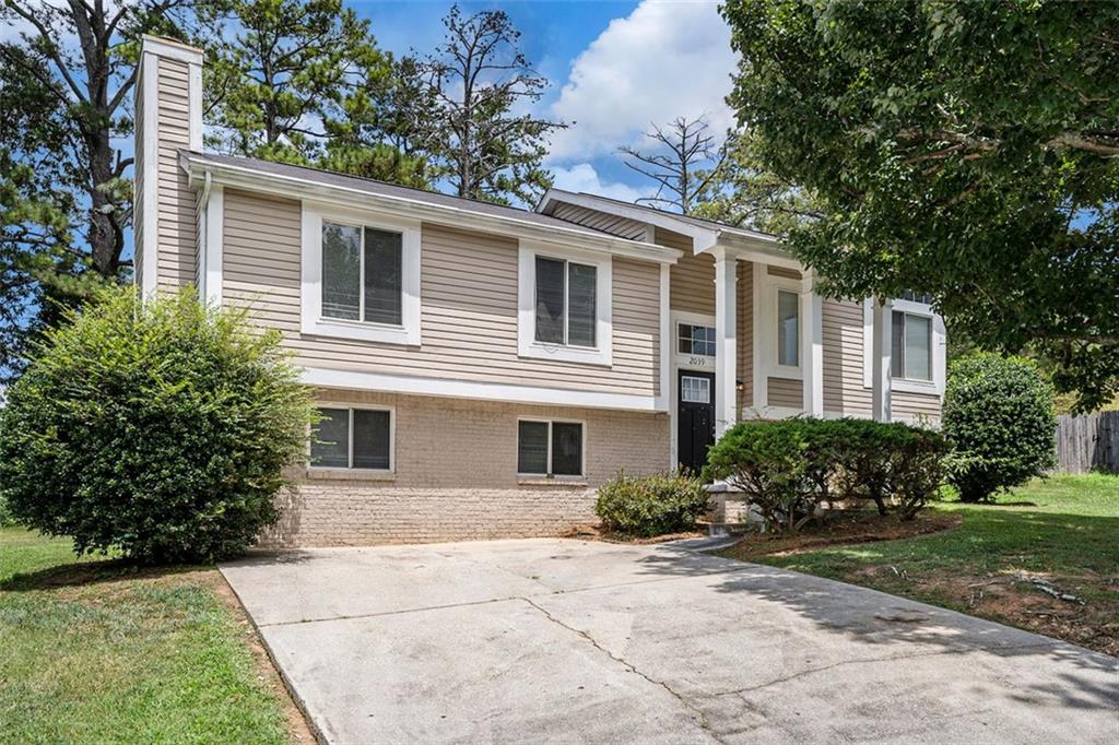 2039 Raintree Place Lithonia, GA 30058 - Photo 18 of 18 a front view of a house with garden