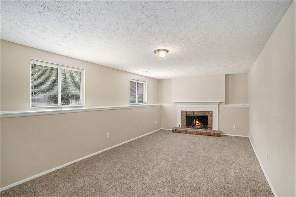 2039 Raintree Place Lithonia, GA 30058 - Photo 10 of 18 an empty room with windows and fireplace