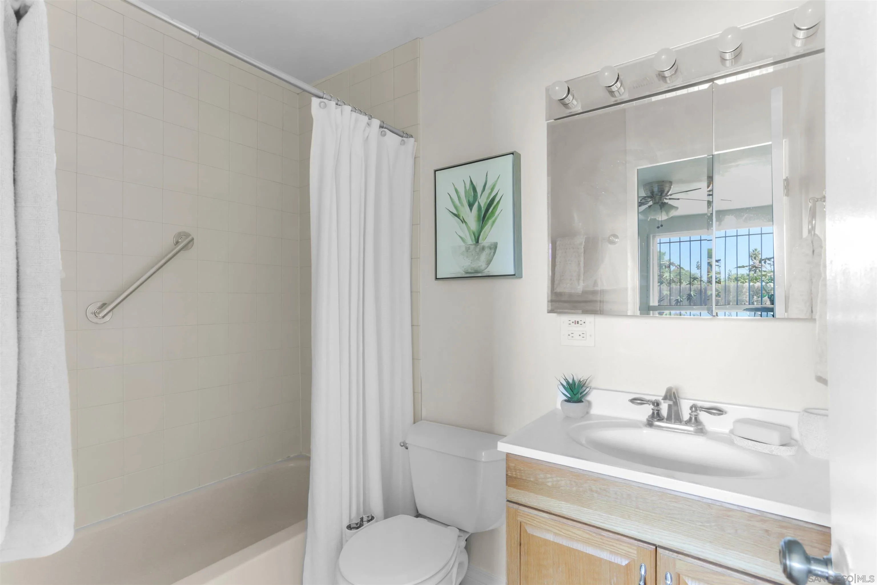 14287 Lolin Lane Poway, CA 92064 - Photo 16 of 35 a bathroom with a granite countertop sink toilet a mirror and shower