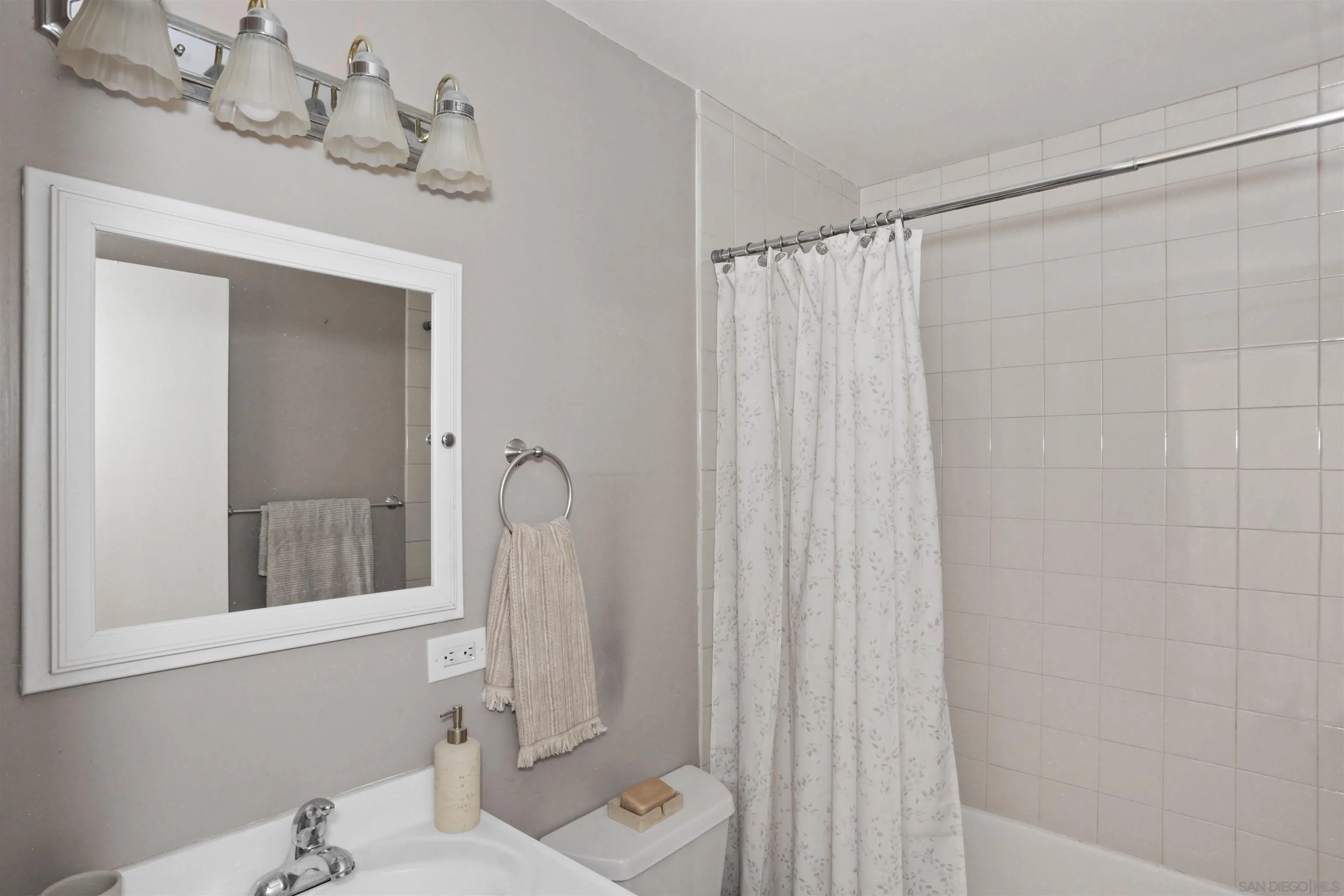 14287 Lolin Lane Poway, CA 92064 - Photo 18 of 35 a bathroom with a sink a mirror and a shower