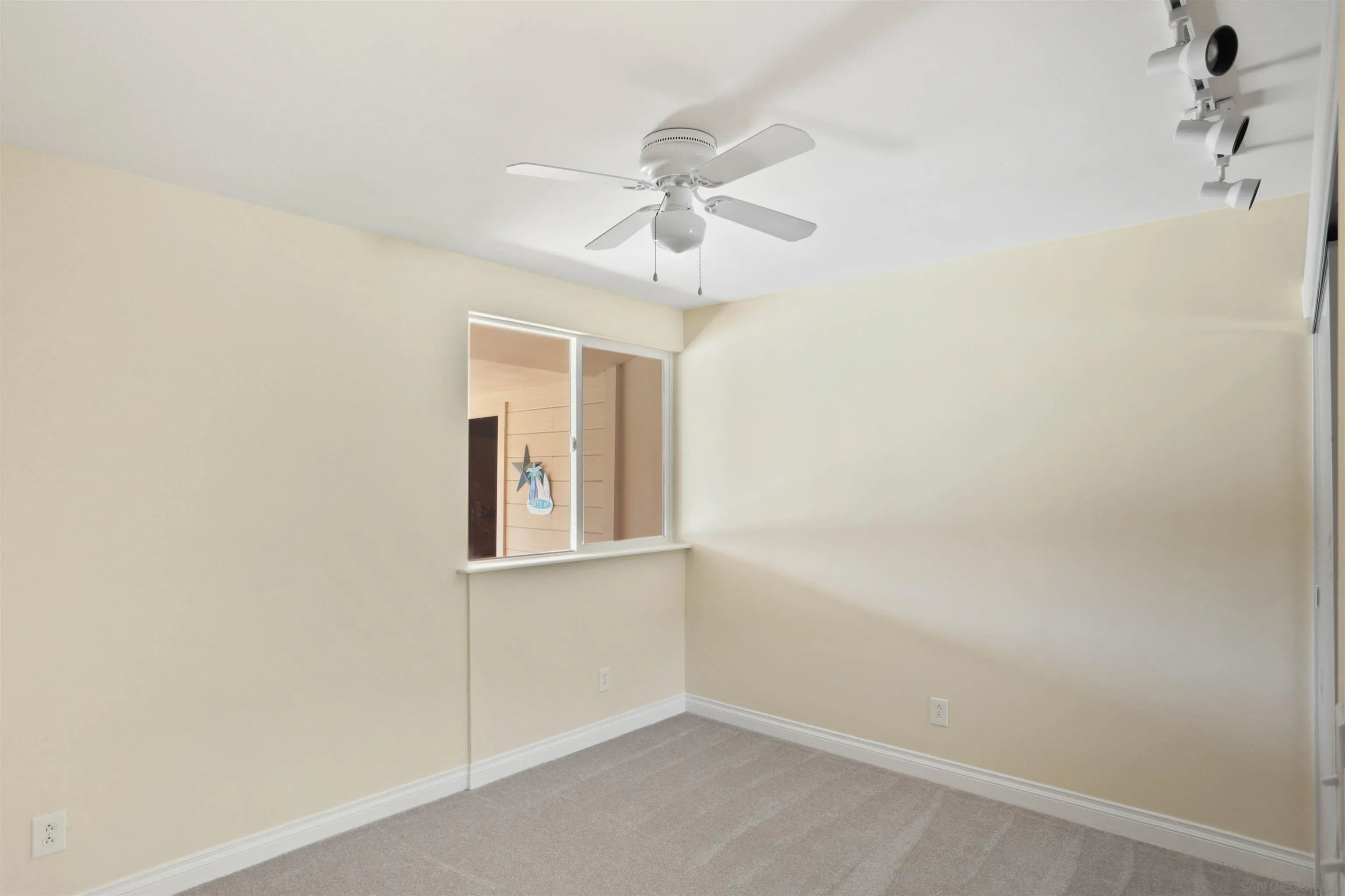 14287 Lolin Lane Poway, CA 92064 - Photo 21 of 35 an empty room with windows and fan