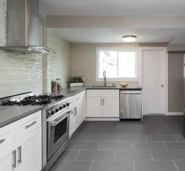 1557 79th Avenue Oakland, CA 94621 - Photo 3 of 11 a white kitchen with a stove top oven sink and stainless steel appliances