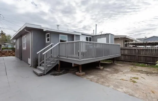 a view of a house with wooden fence