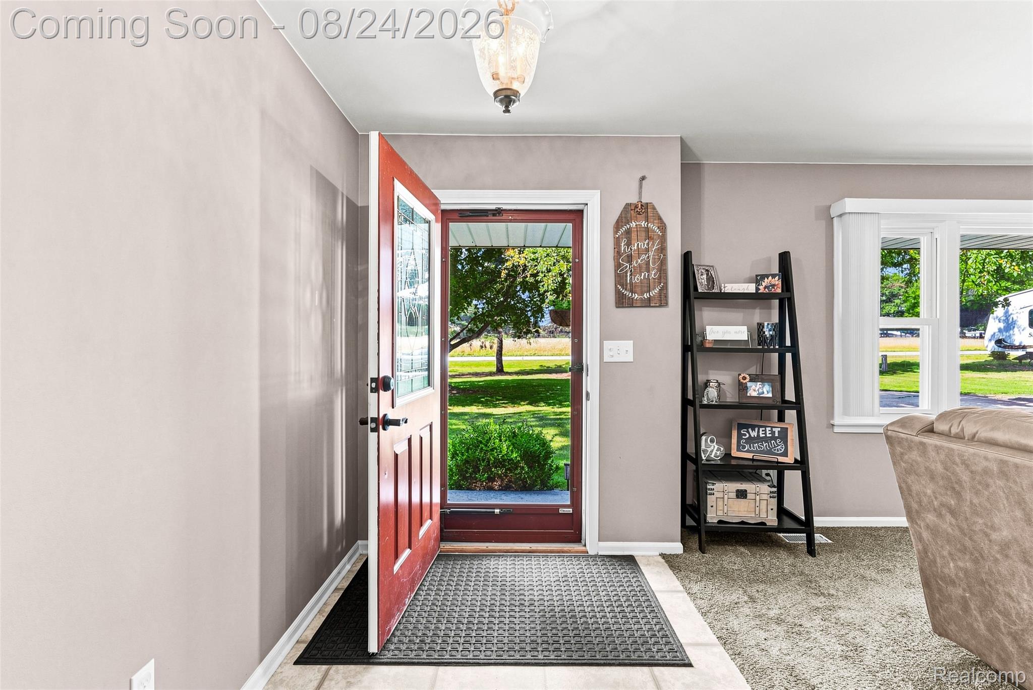 2310 Peppermill Road Lapeer, MI 48446 - Photo 8 of 35 Entryway with a red door, transom window, and overhead lighting