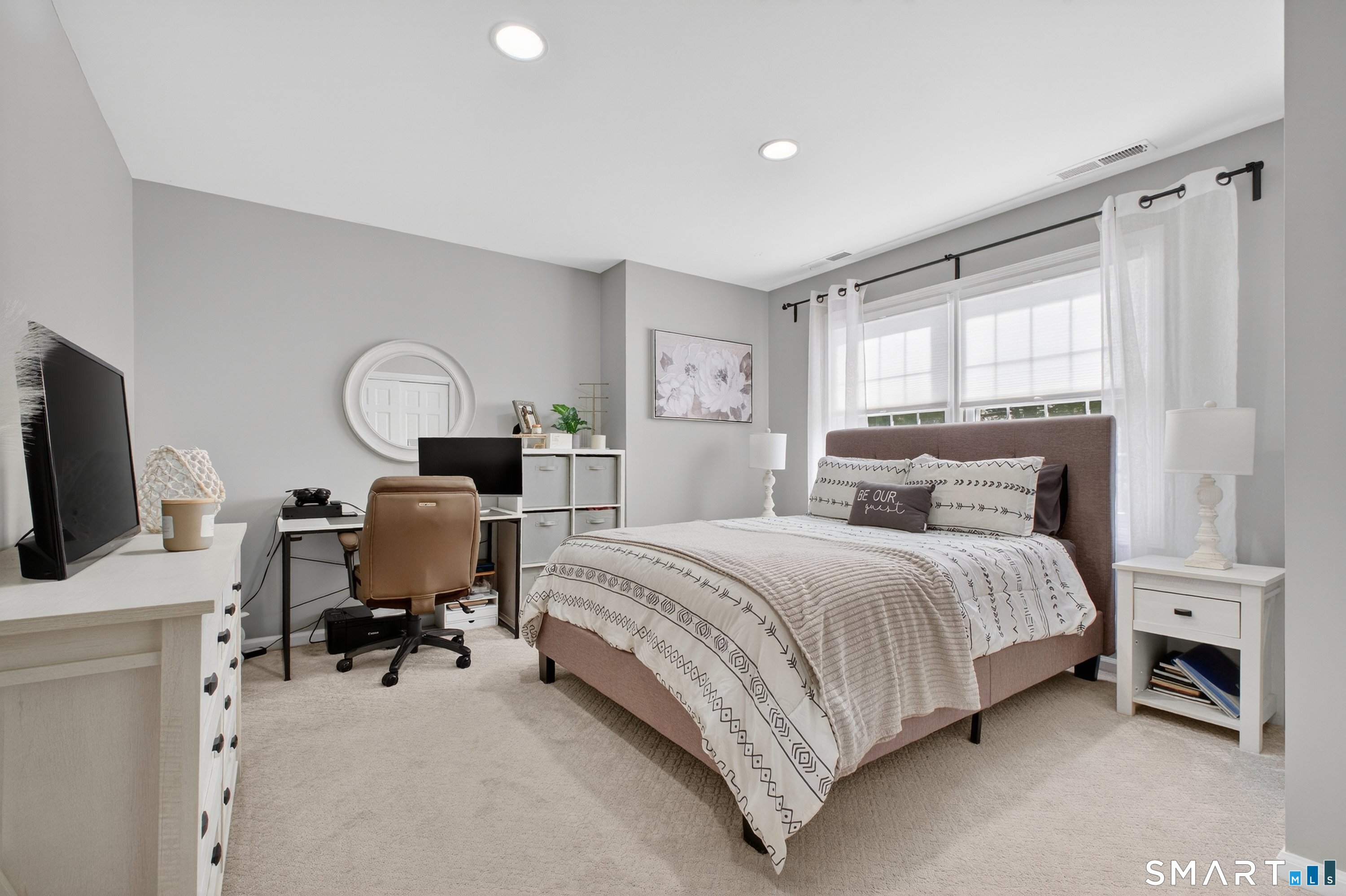 19 Prospect Ridge, Unit 41 Ridgefield, CT 06877 - Photo 21 of 29 a bedroom with a bed table chair and a flat screen tv