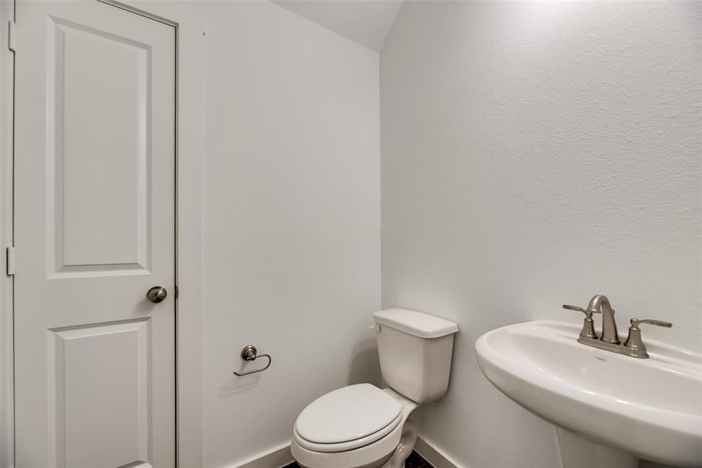 208 Venice Avenue Flower Mound, TX 75028 - Photo 8 of 17 a white toilet sitting next to a bathroom sink