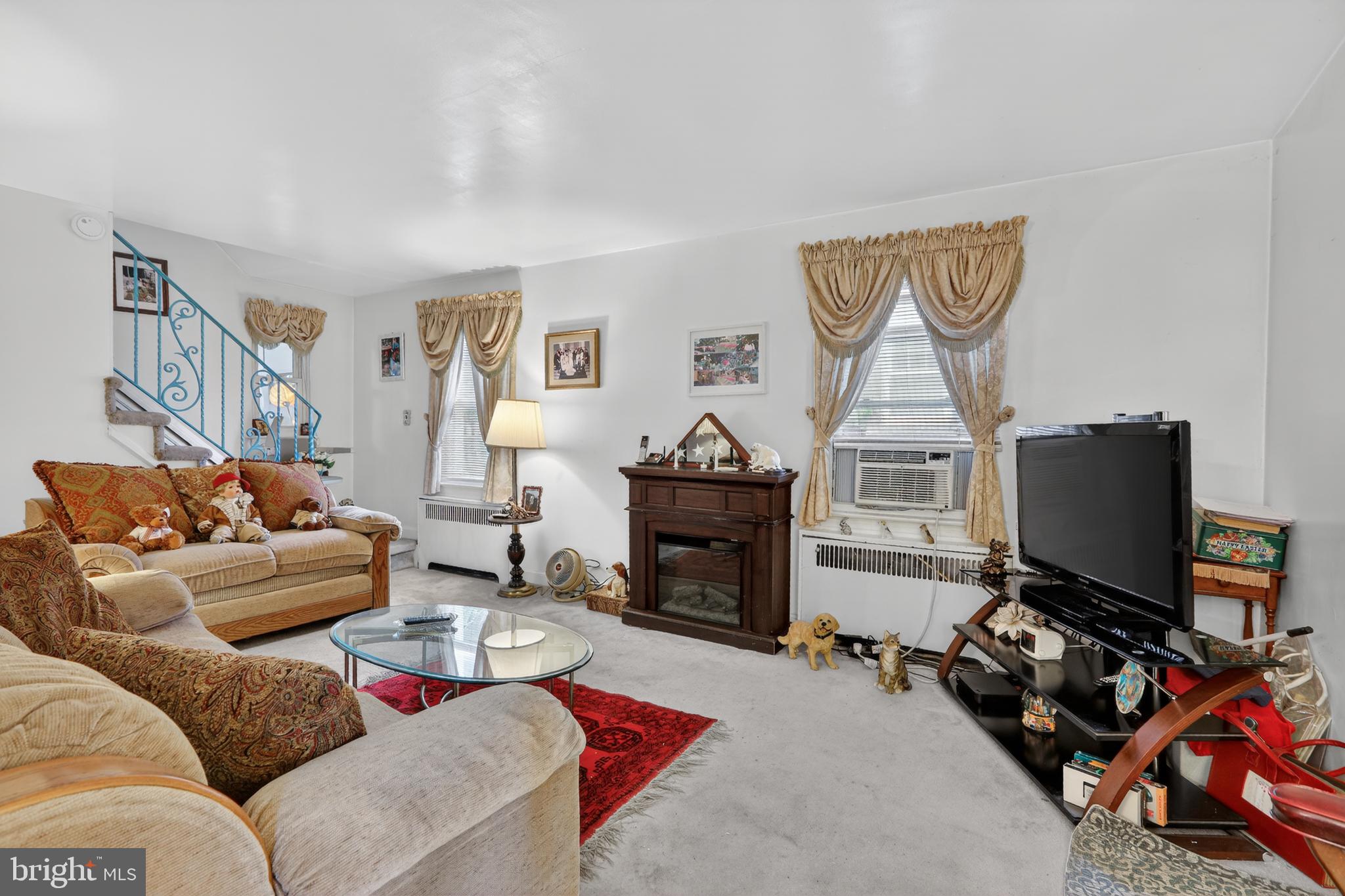 1424 Burmont Road Havertown, PA 19083 - Photo 4 of 37 a living room with furniture a fireplace and a flat screen tv