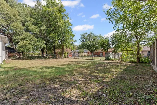 a view of outdoor space with garden and trees
