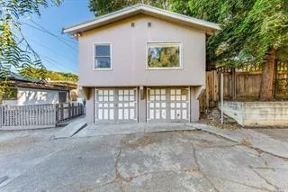 a view of house with backyard and deck