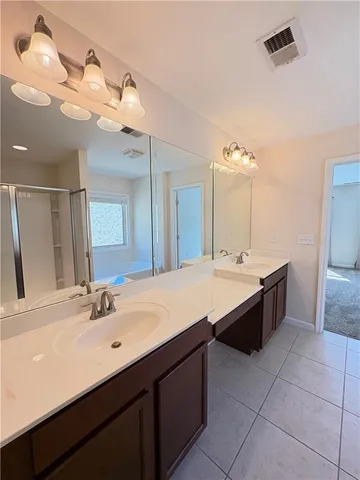 a bathroom with a glass shower door