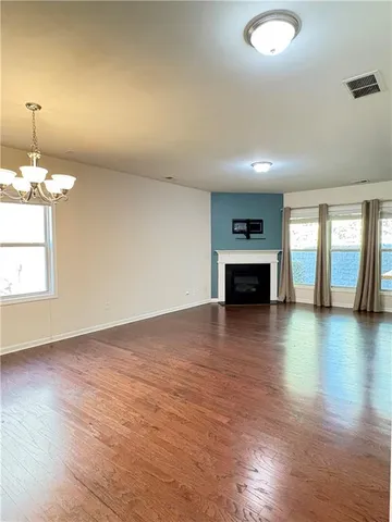 a view of a room with wooden floor
