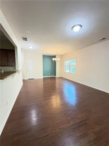 a large kitchen with stainless steel appliances kitchen island granite countertop a large stove top oven a refrigerator with island and chairs