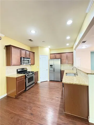 a kitchen with stainless steel appliances a stove and a microwave