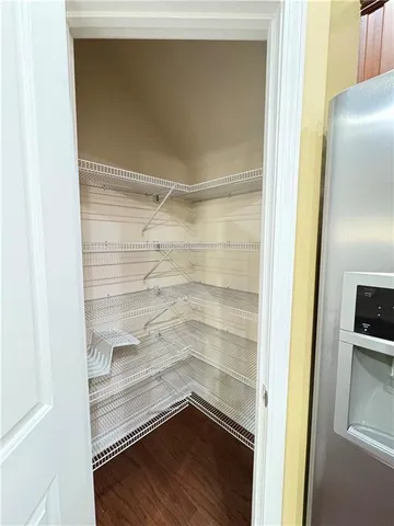 a kitchen with wooden floors and wooden cabinets