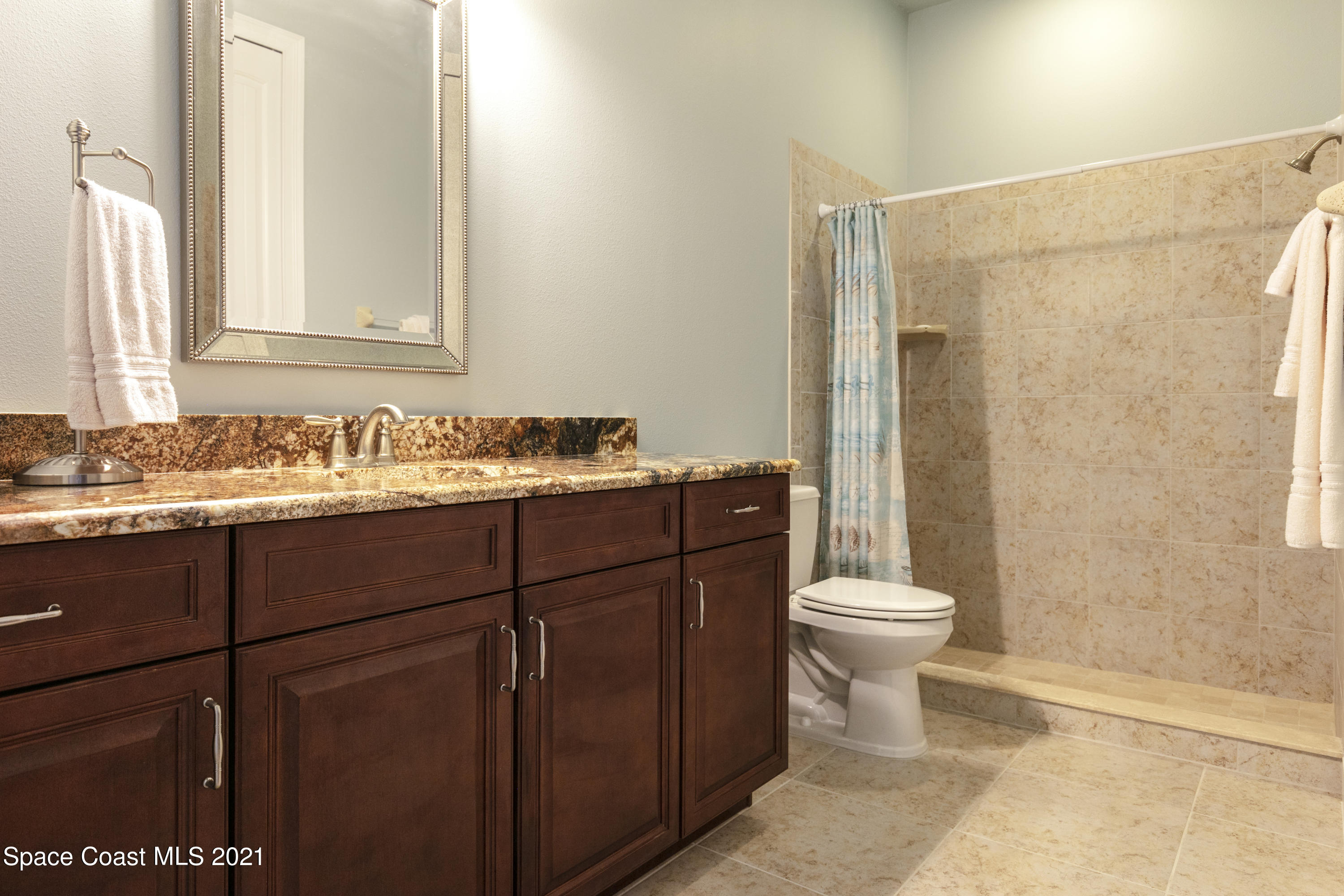 4584 Preservation Circle Melbourne, FL 32934 - Photo 15 of 34 a bathroom with a sink toilet and shower