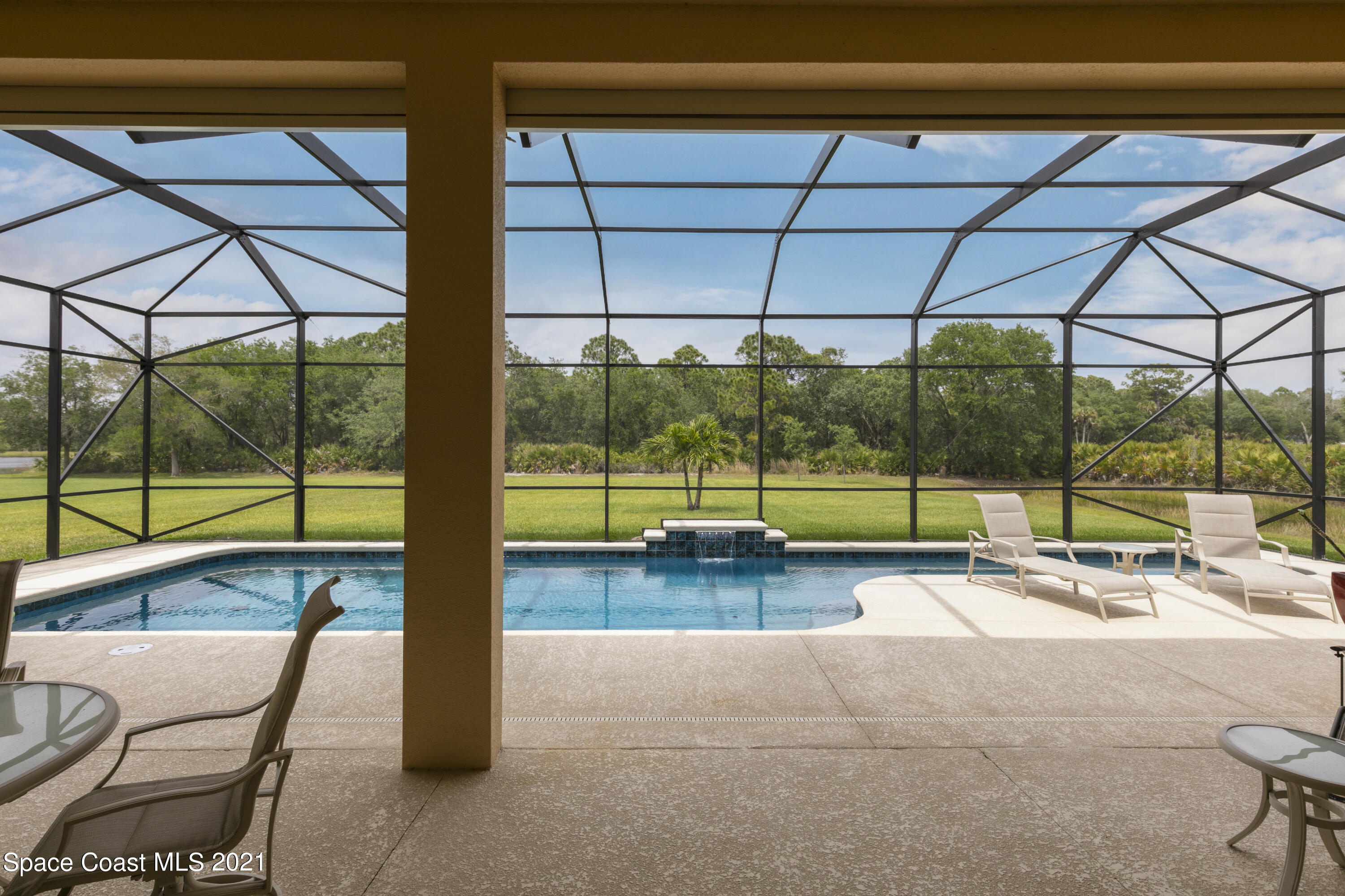 4584 Preservation Circle Melbourne, FL 32934 - Photo 20 of 34 a view of a swimming pool and lounge chairs