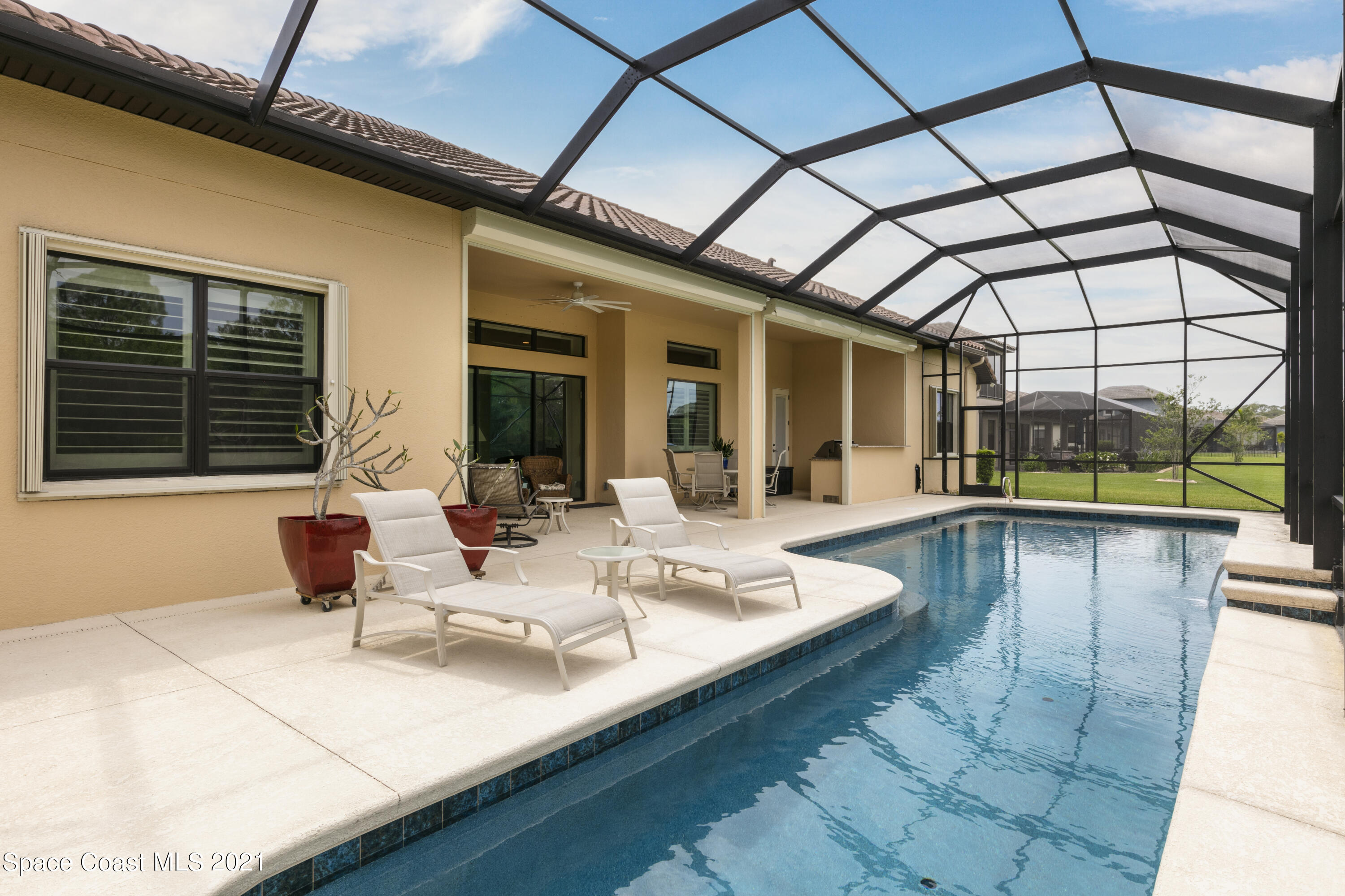 4584 Preservation Circle Melbourne, FL 32934 - Photo 22 of 34 a view of a patio with swimming pool table and chairs
