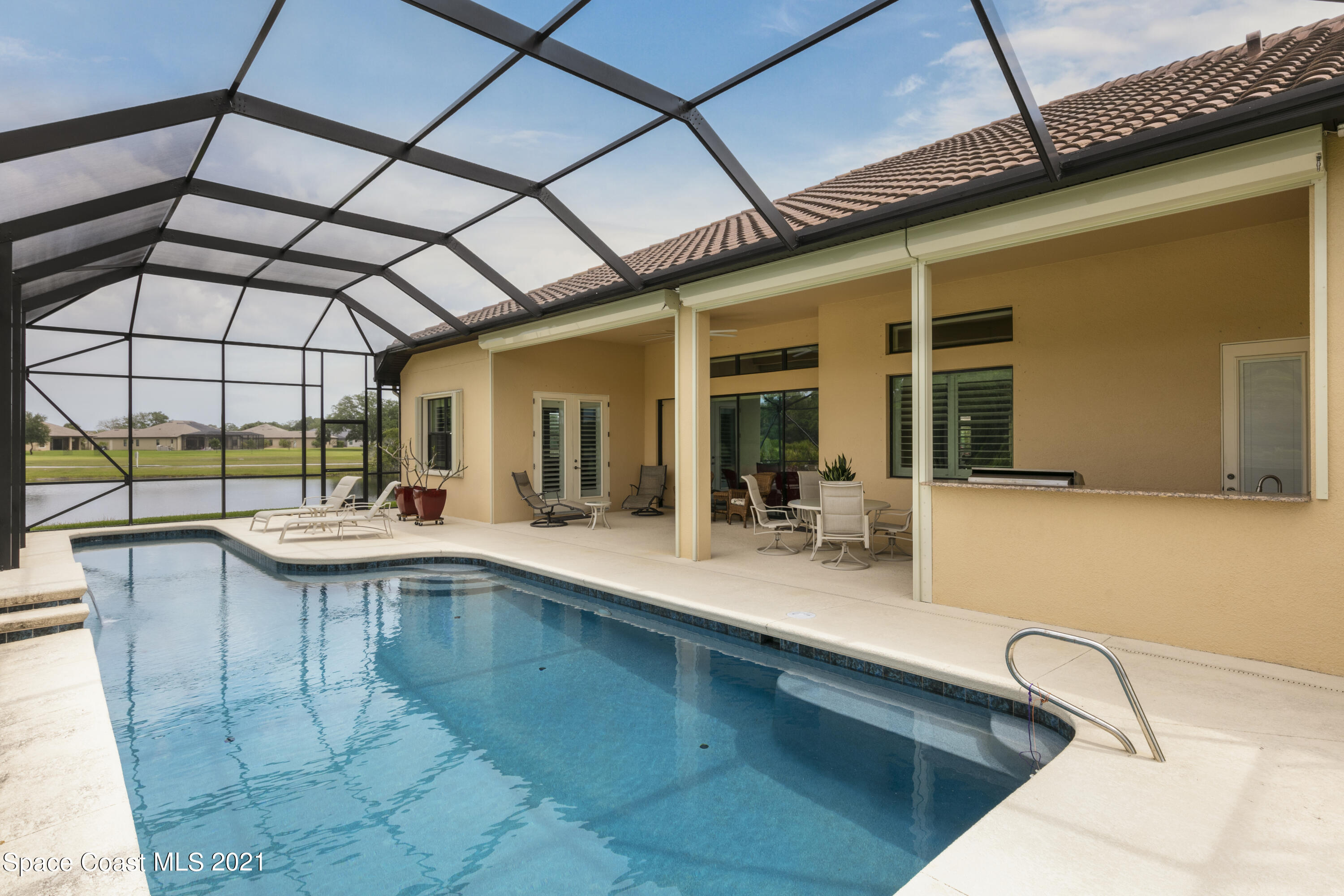 4584 Preservation Circle Melbourne, FL 32934 - Photo 25 of 34 a view of a kitchen with a sink and sitting area
