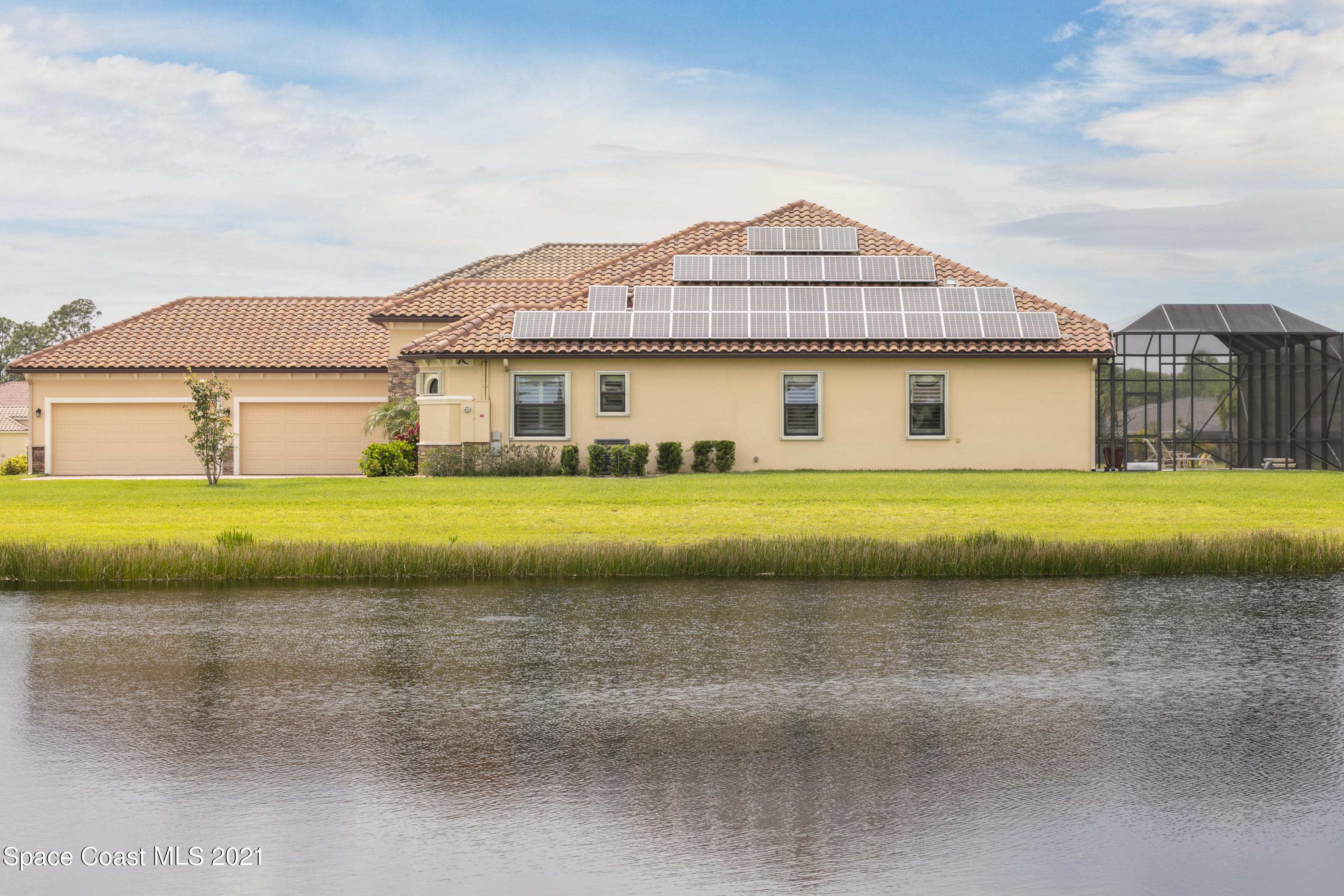 4584 Preservation Circle Melbourne, FL 32934 - Photo 27 of 34 a front view of a house with a garden and yard