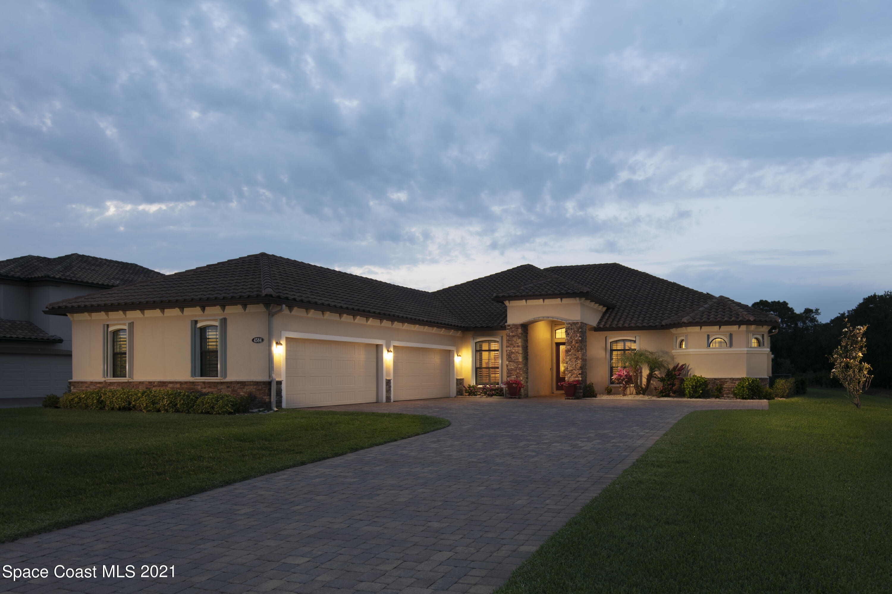 4584 Preservation Circle Melbourne, FL 32934 - Photo 30 of 34 a front view of a house with a yard and garage