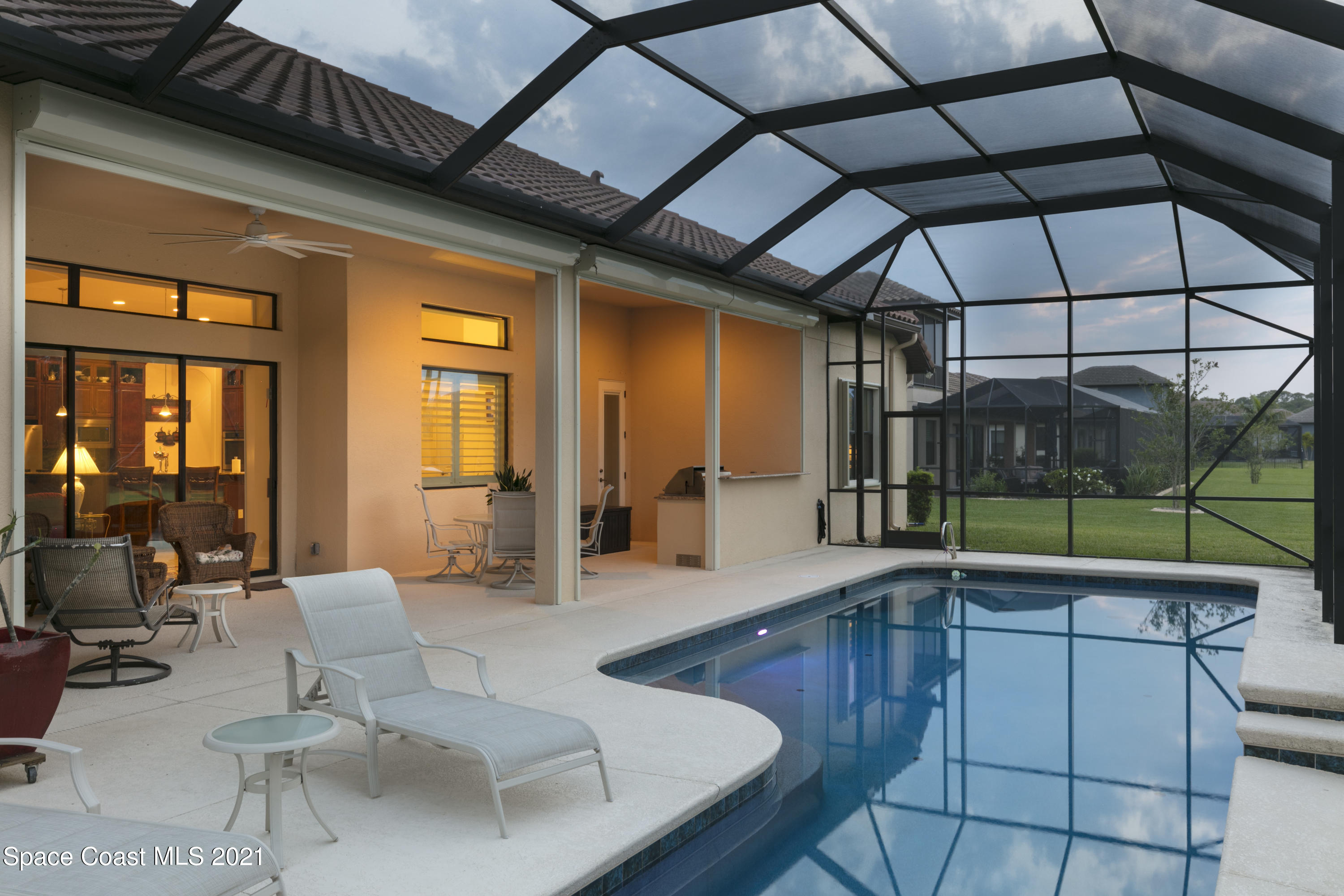4584 Preservation Circle Melbourne, FL 32934 - Photo 32 of 34 a view of a living room and kitchen with a large window