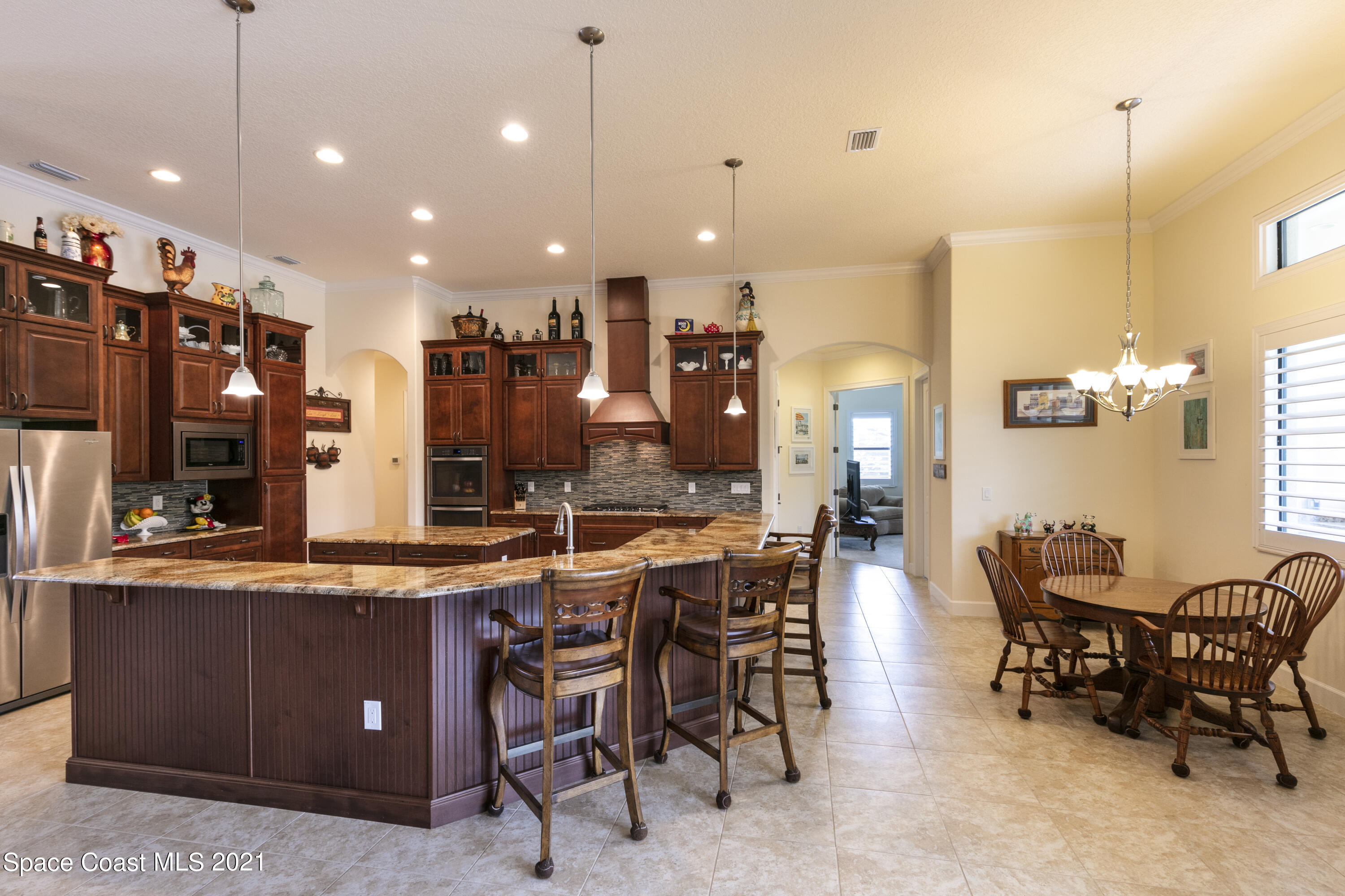4584 Preservation Circle Melbourne, FL 32934 - Photo 6 of 34 a large kitchen with a table and chairs