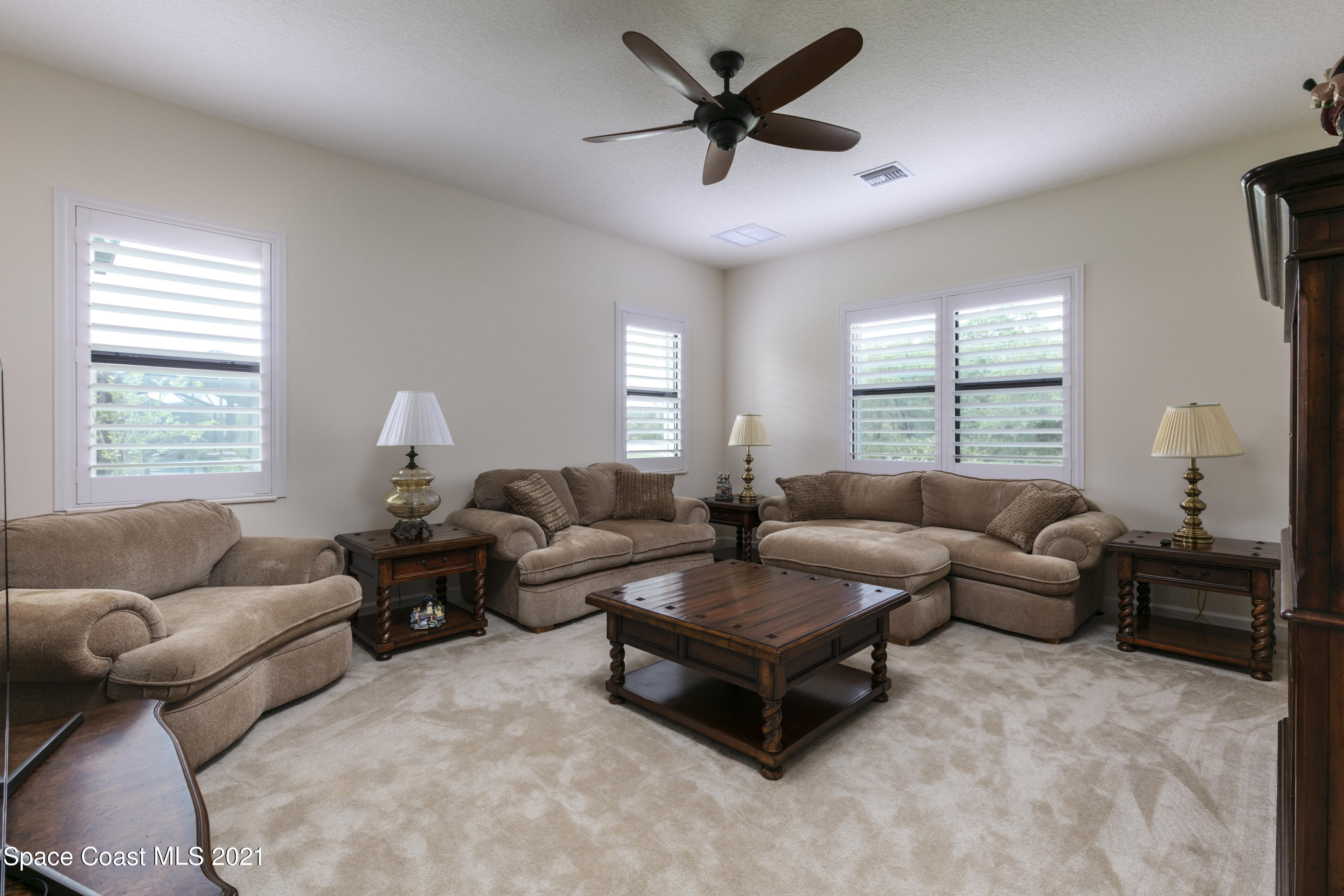 4584 Preservation Circle Melbourne, FL 32934 - Photo 9 of 34 a living room with furniture and a large window