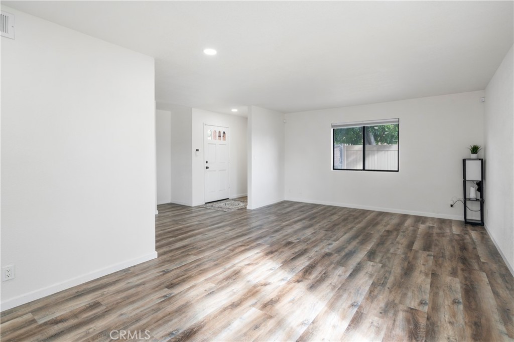 700 West 2nd Street Azusa, CA 91702 - Photo 11 of 75 an empty room with wooden floor and windows