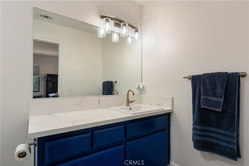 700 West 2nd Street Azusa, CA 91702 - Photo 19 of 75 a bathroom with a sink a mirror and shower