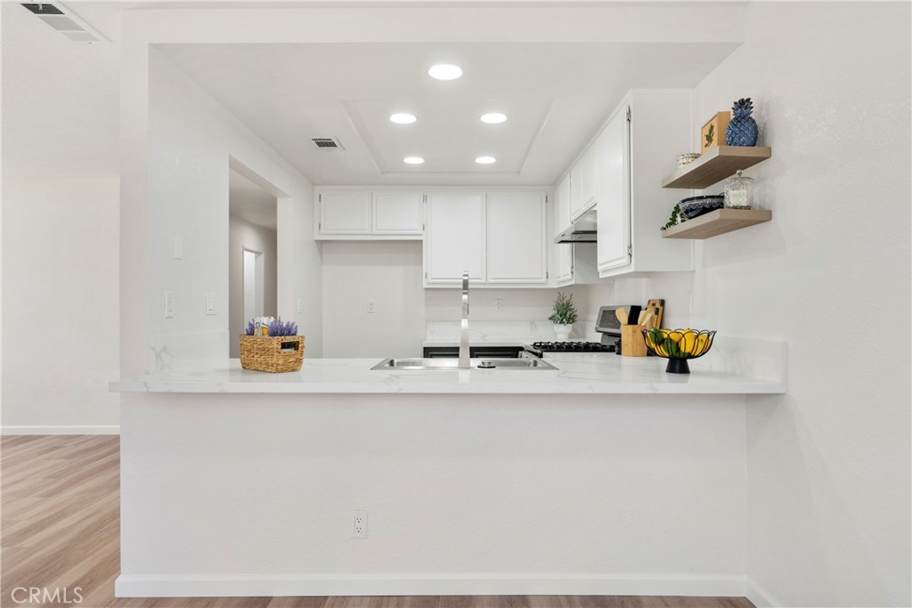 700 West 2nd Street Azusa, CA 91702 - Photo 30 of 75 a kitchen with a sink a stove and a refrigerator