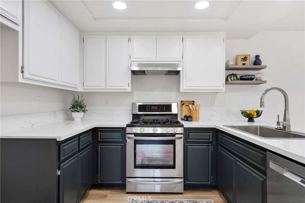 700 West 2nd Street Azusa, CA 91702 - Photo 31 of 75 a kitchen with cabinets stainless steel appliances and wooden floor