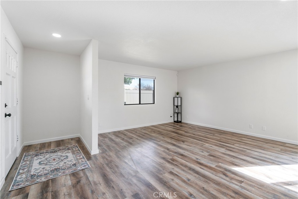 700 West 2nd Street Azusa, CA 91702 - Photo 6 of 75 a view of empty room with wooden floor and fan