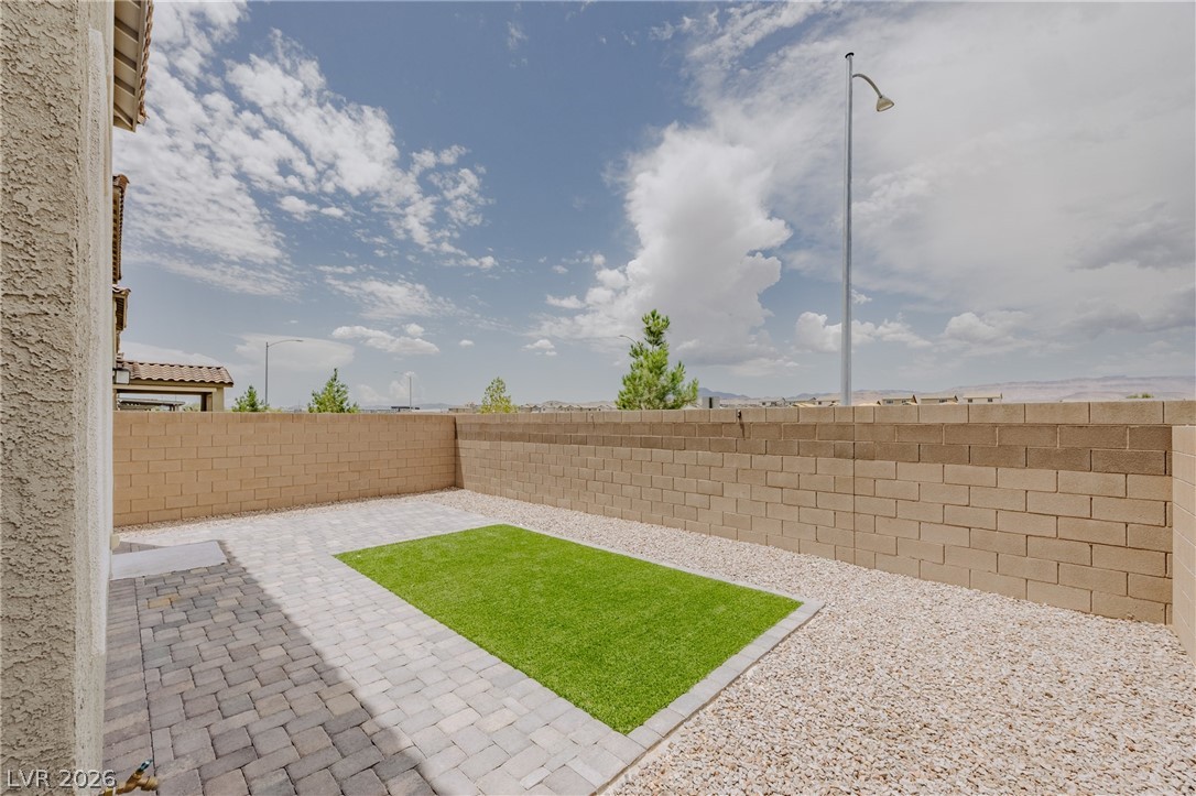 5927 Coja Street Las Vegas, NV 89113 - Photo 6 of 32 Fenced backyard with a patio area