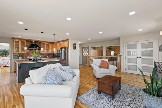 a view of a room with furniture and wooden floor