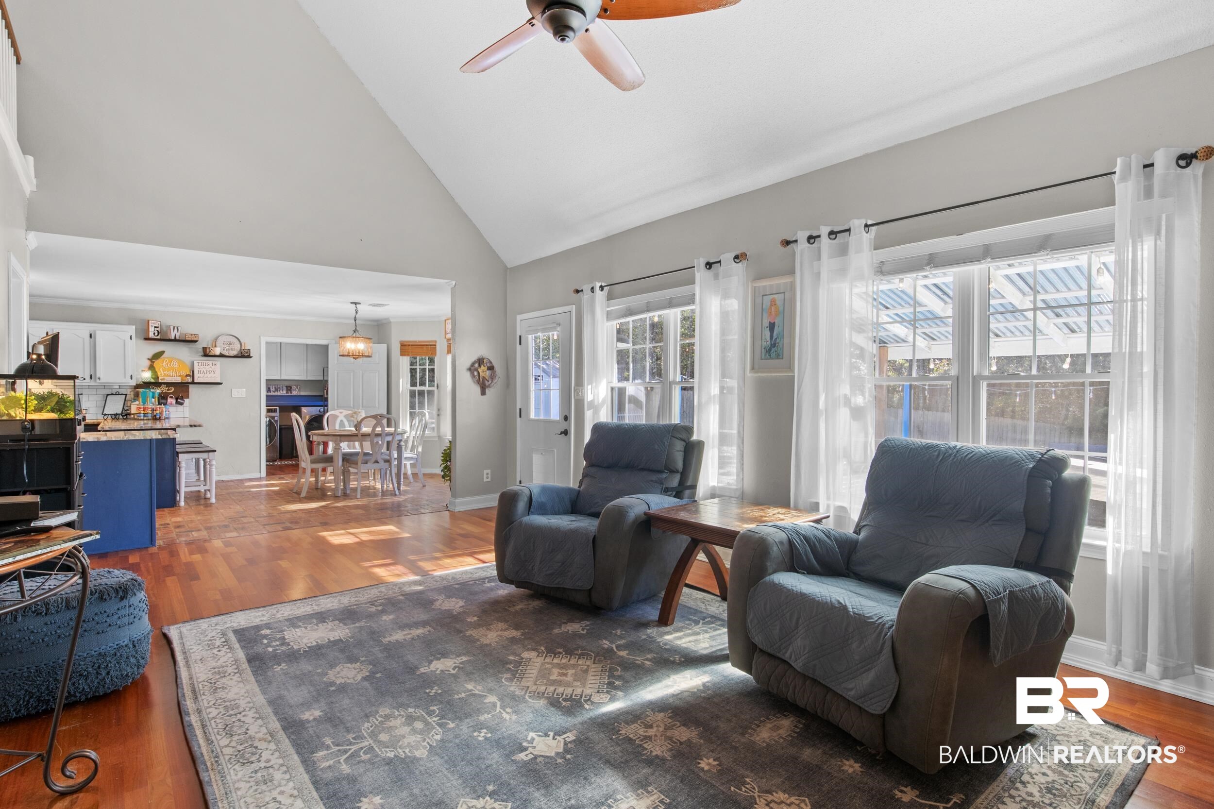 131 Marikesh Drive Daphne, AL 36526 - Photo 18 of 29 Living room featuring ceiling fan, high vaulted ceiling, and dark hardwood / wood-style flooring
